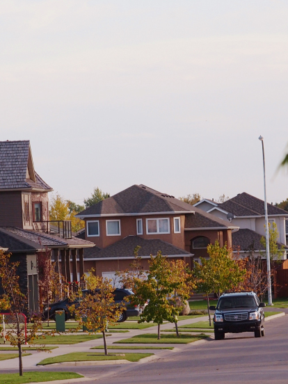 a residential street with a vehicle parked.