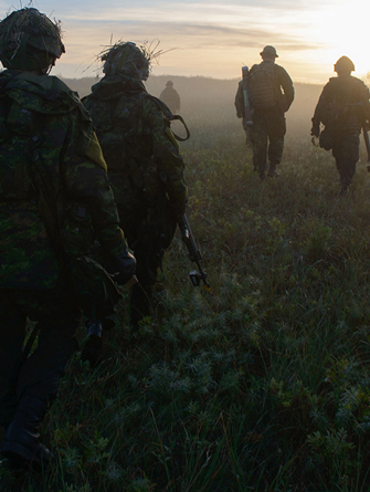 soldiers walking in a field.